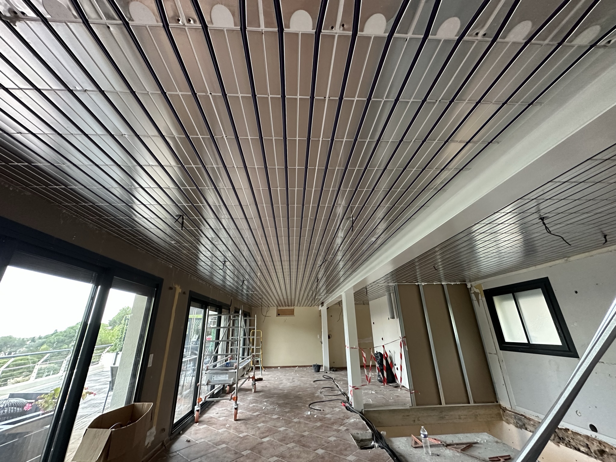 le plafond rafraîchissant absorbe les apports solaires des baies vitrées